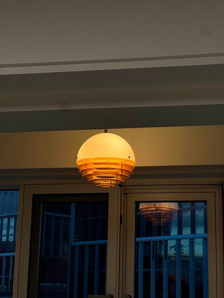 Real review image of the pendant lamp glowing near a window