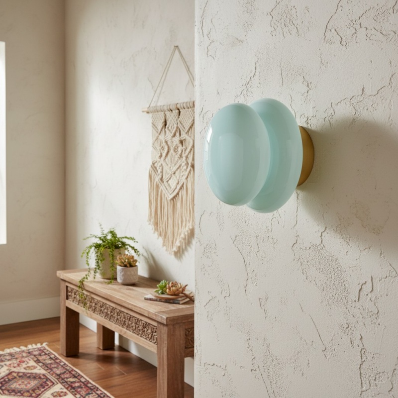 Opal glass wall lamp beside a sofa