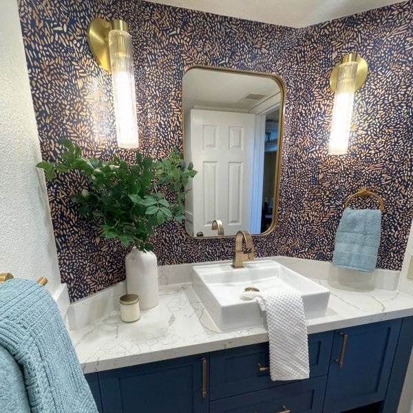 Customer bathroom vanity with brass Rivora sconces