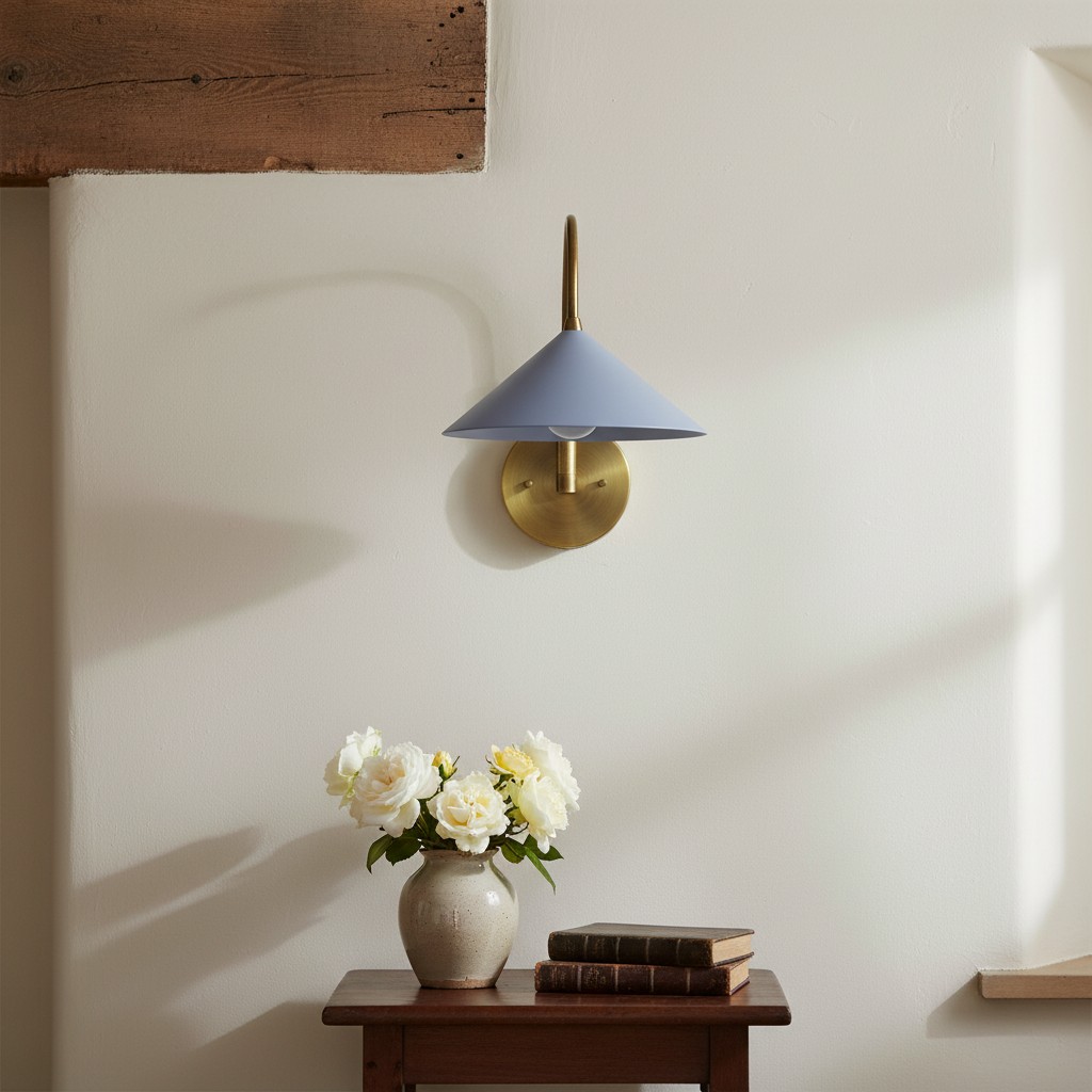 Curva sconce with blue shade above a table