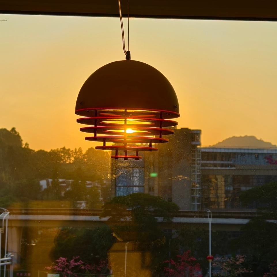 Orange sunset pendant lamp in front of sunset scenery