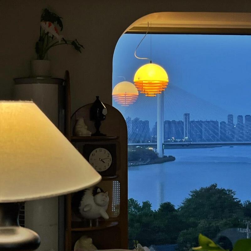 Sunset pendant lamp beside a window view