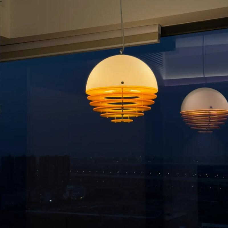 Pendant lamp and reflection glowing against the night window