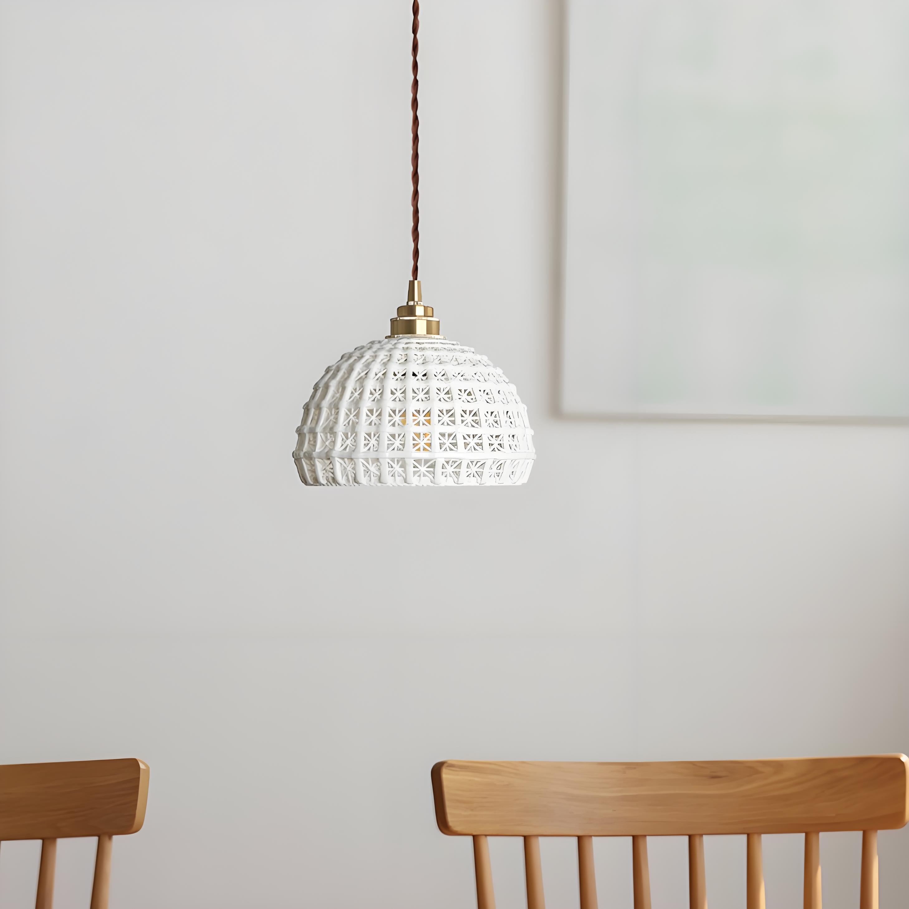 Pendant light installed above dining chairs in a bright room