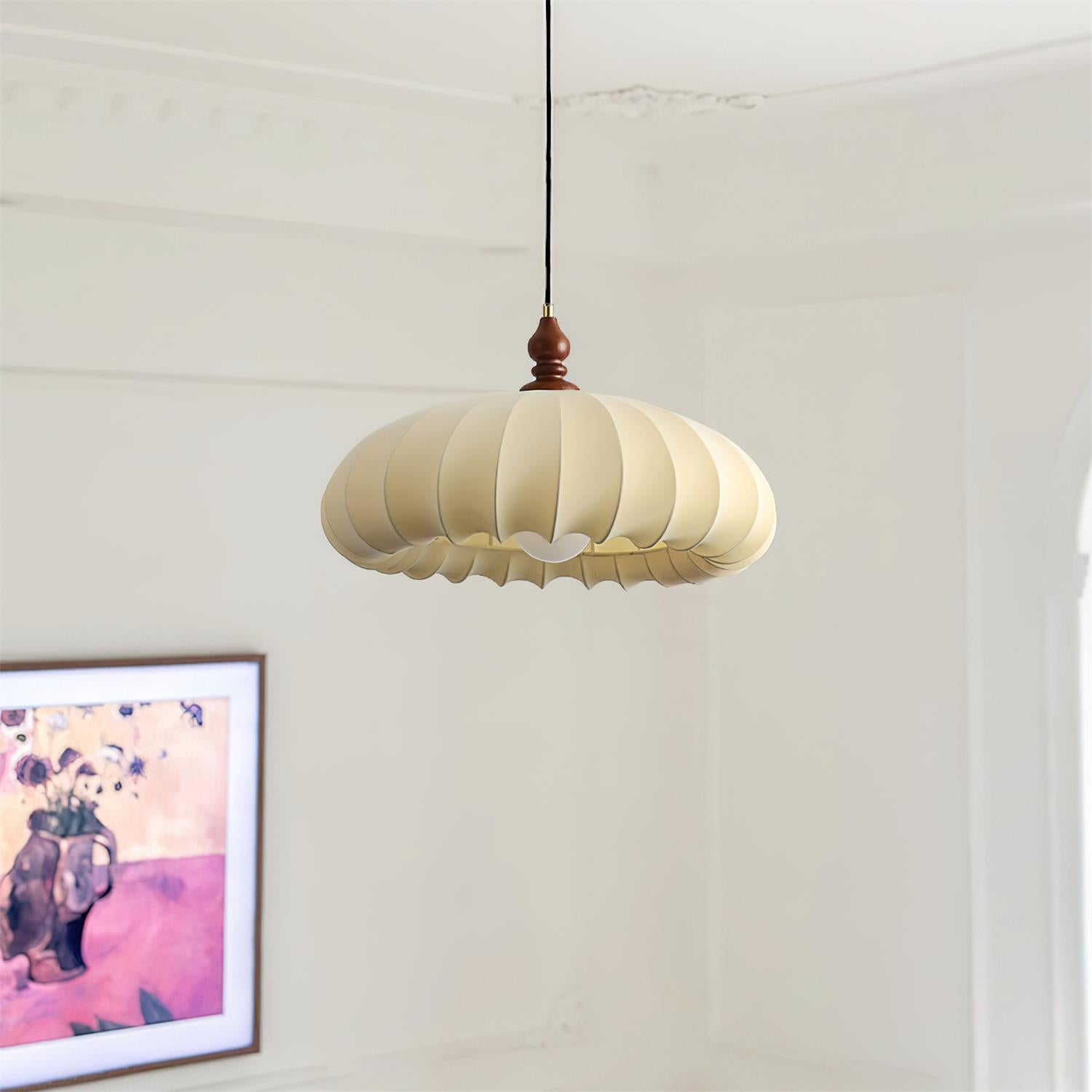 Pleated pendant light in a minimal neutral room scene