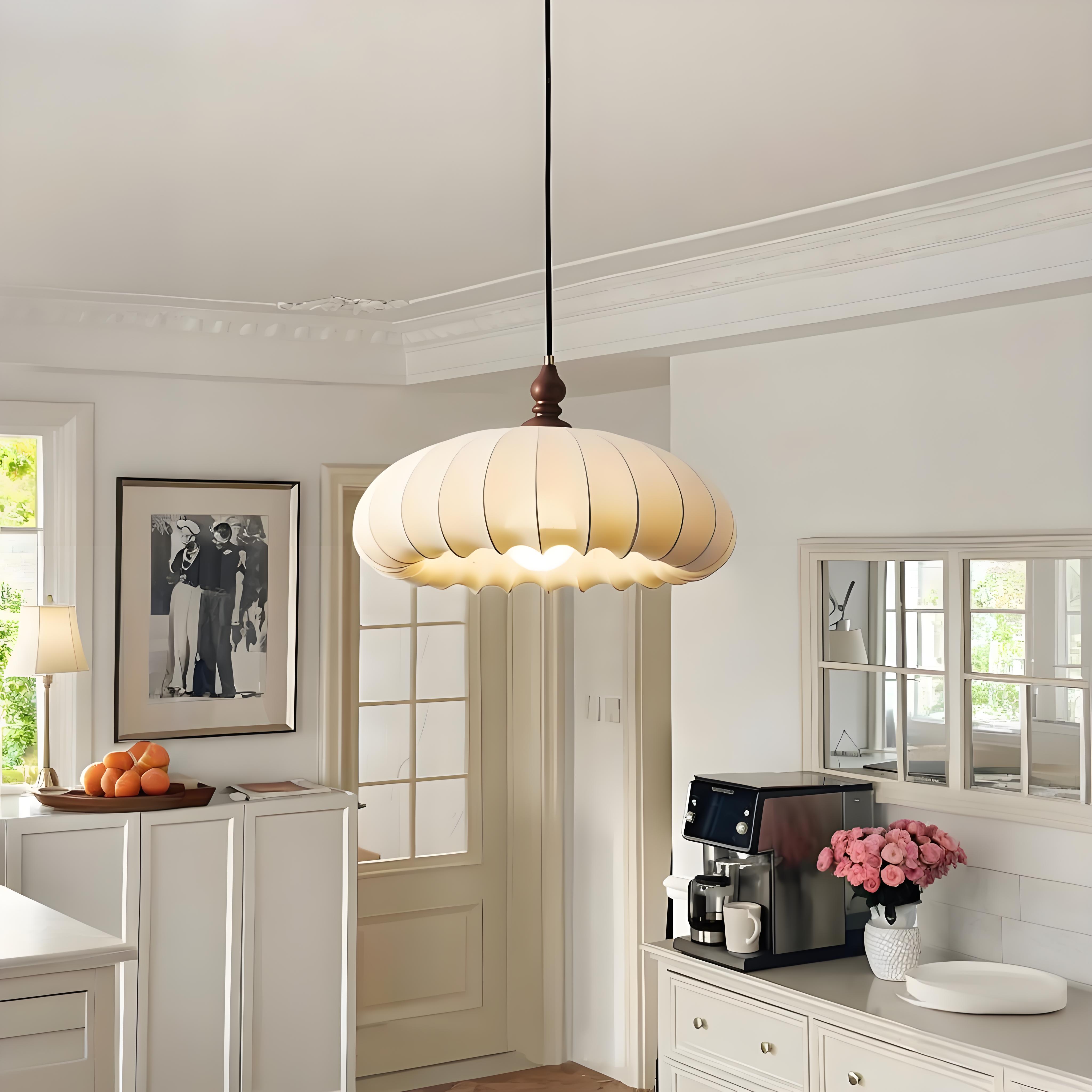 Pleated fabric pendant light in a bright kitchen and dining entry scene