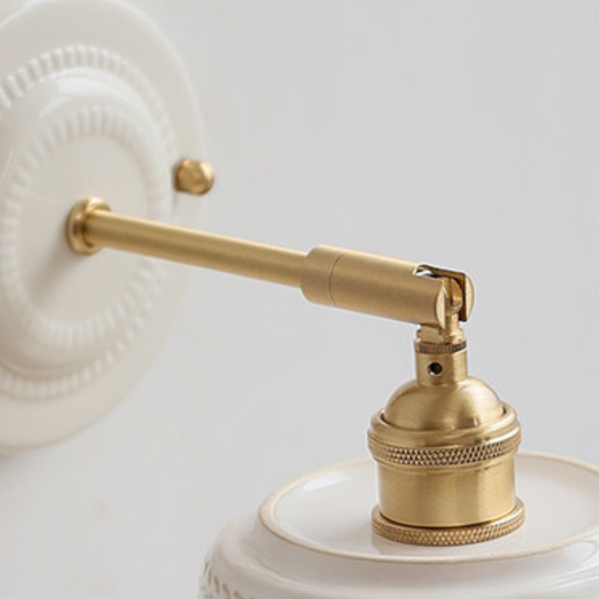 Close-up of brass-tone arm and socket connection