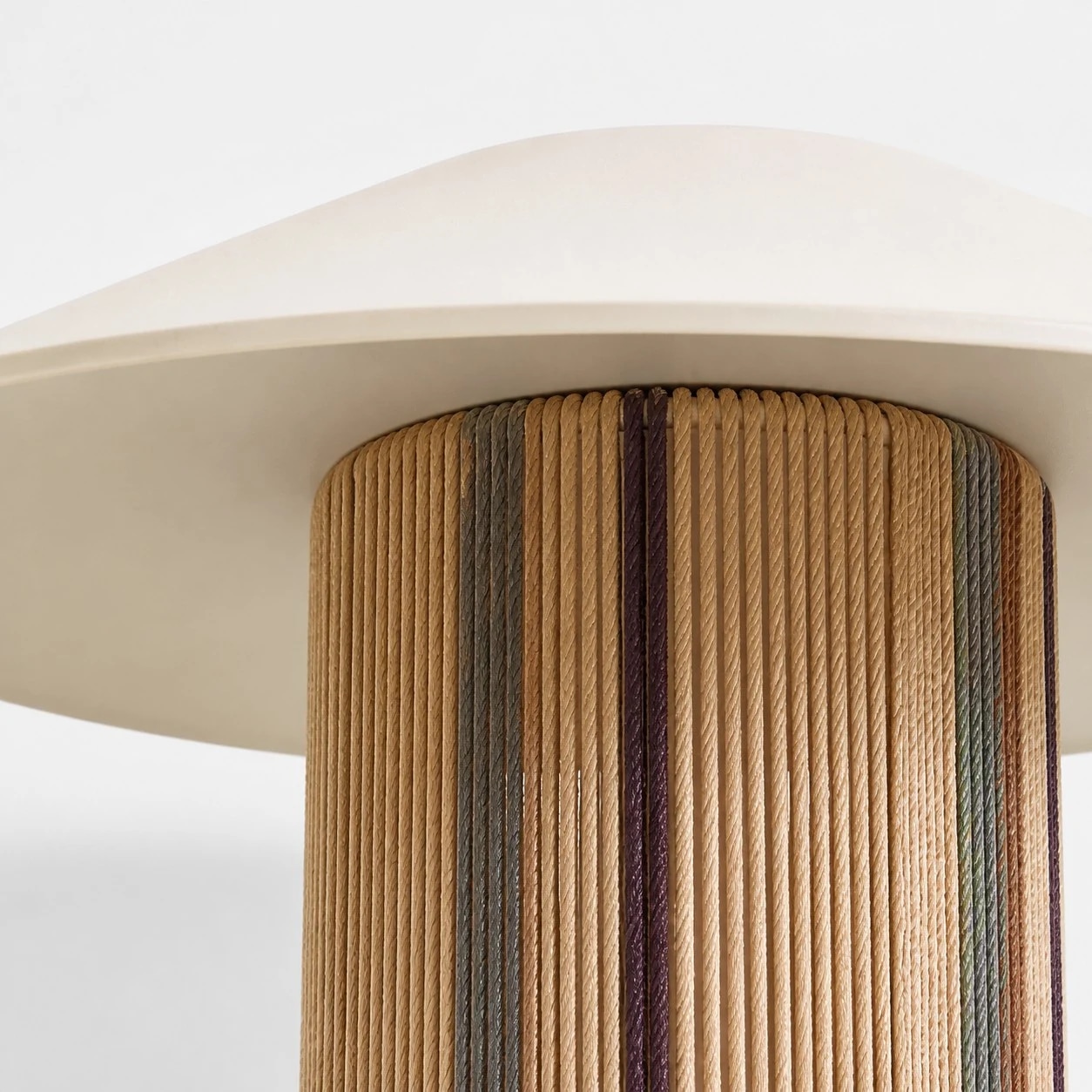 Underside detail of the pleated shade and woven cylindrical body