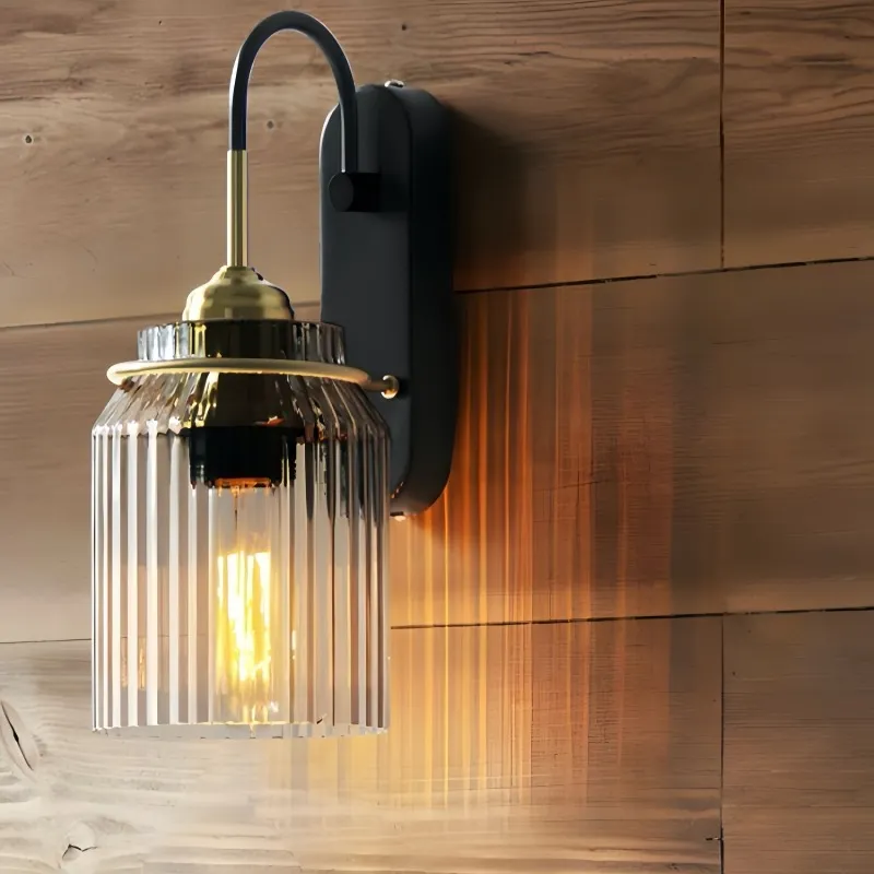 Close-up of the bronze-toned iron frame, ribbed glass enclosure and wall mounting plate