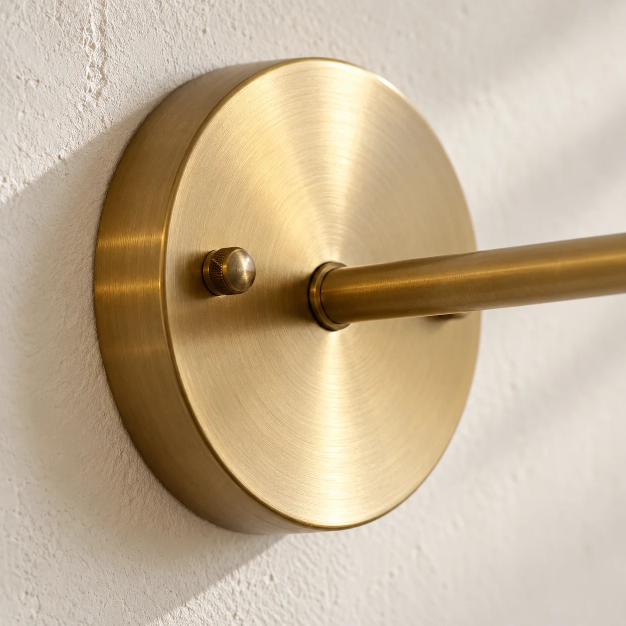 Close-up of the round brass backplate and arm joint
