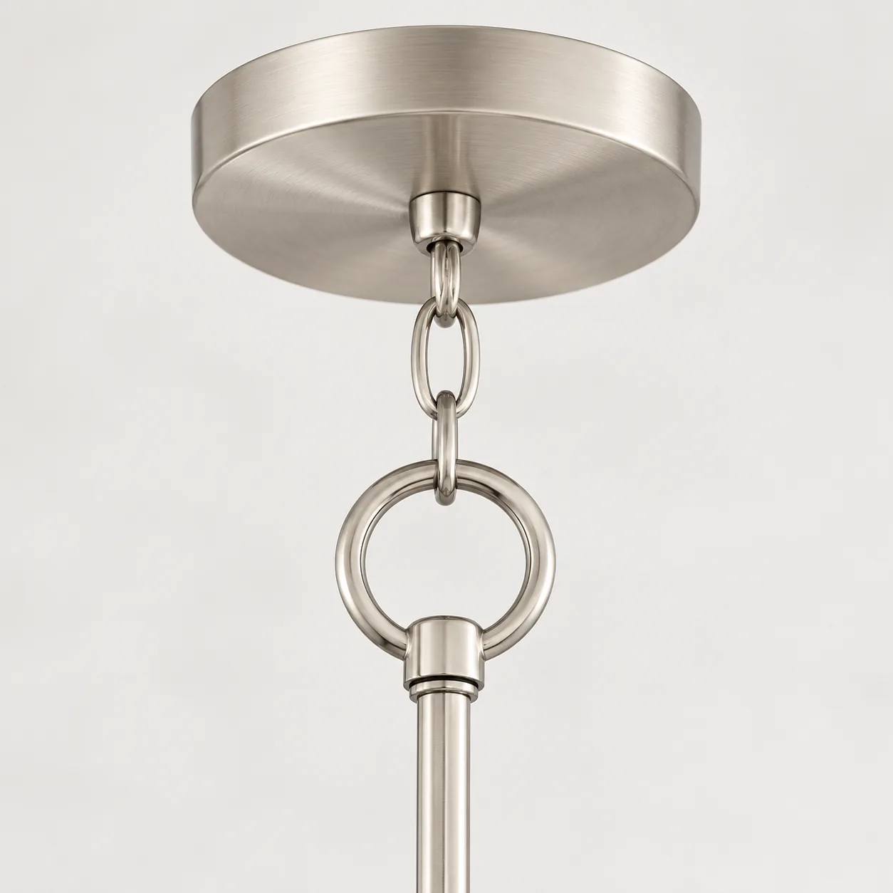 Close view of the round canopy, chain, ring, and stem
