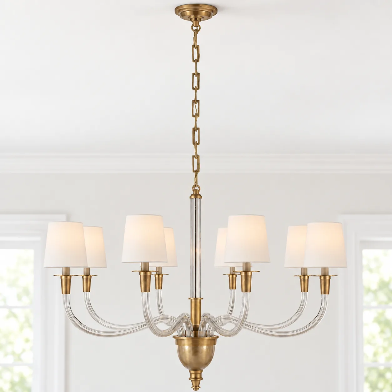 Hand-rubbed antique brass crystal linen chandelier on a ceiling in daylight